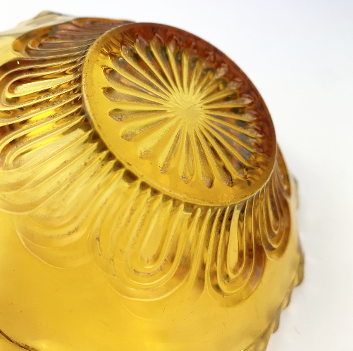 Art deco arch detail on amber glass bowl