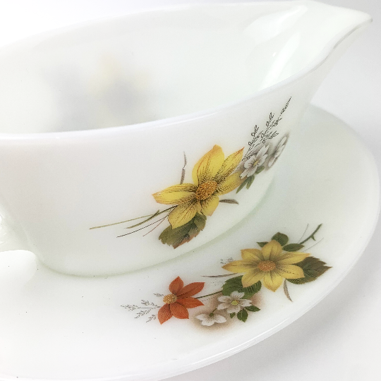 Close up view of 1970's collectible Pyrex gravy boat and saucer