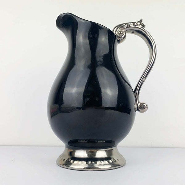 Large black ceramic jug with silver handle