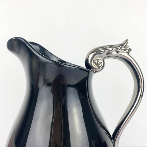 Silver scroll handle on ceramic pitcher