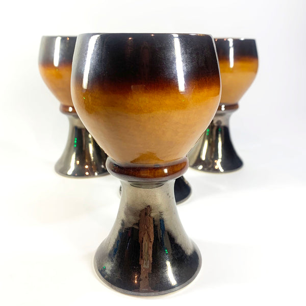 Close up of orange and brown 70's wine goblet