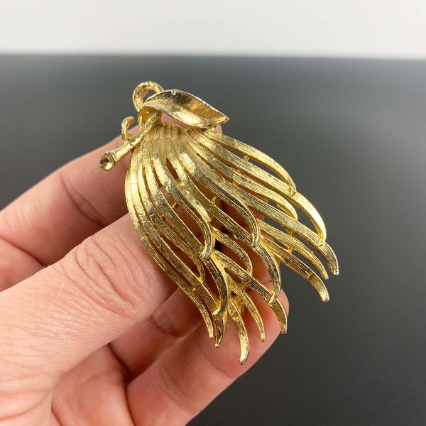 Gold toned feathered leaf style brooch