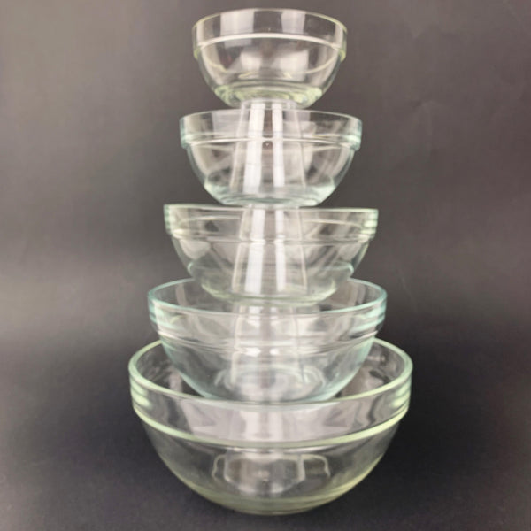 Nested clear glass mixing bowls stacked