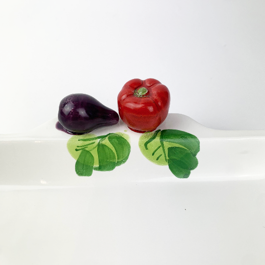 Ceramic vegetables on rim of Italian platter