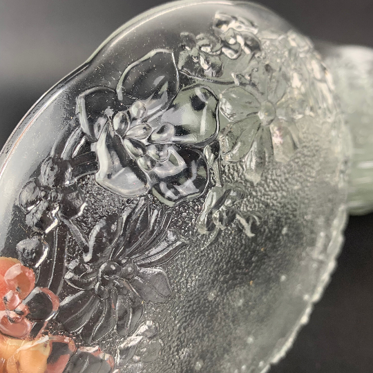 Close up detail of pressed rose design on vintage glass bowl