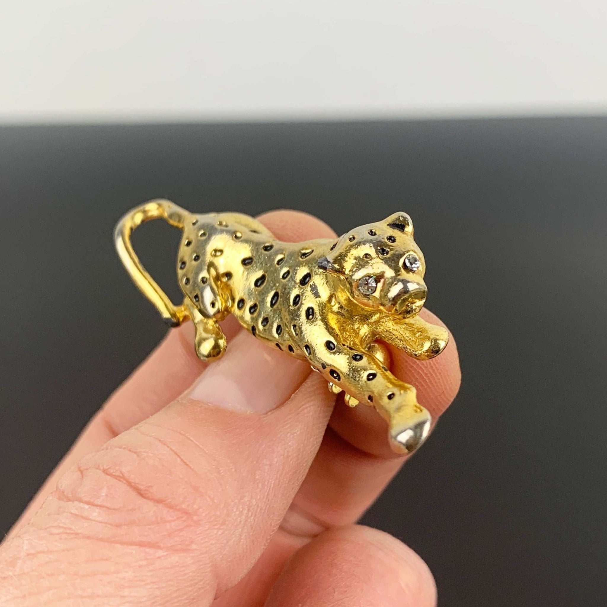 Gold leopard brooch with black enamel spots