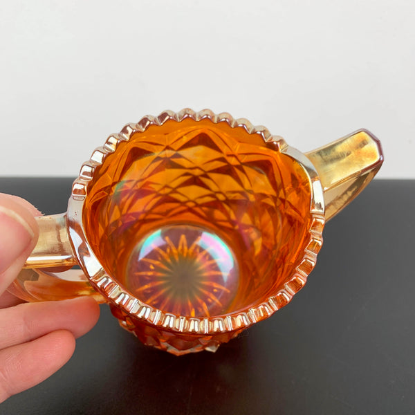 Marigold carnival glass twin handled sugar bowl with sawtooth rim