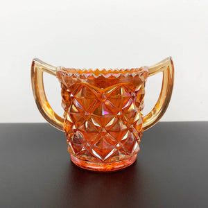 Marigold carnival glass twin handled sugar bowl with sawtooth rim