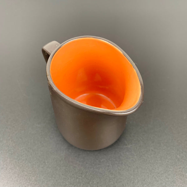 Orange interior of vintage sauce jug