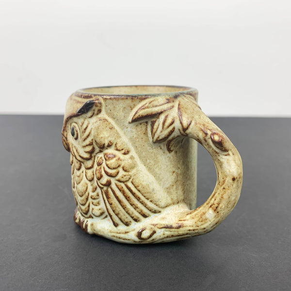 Vintage pottery egg cup with owl and branch handle