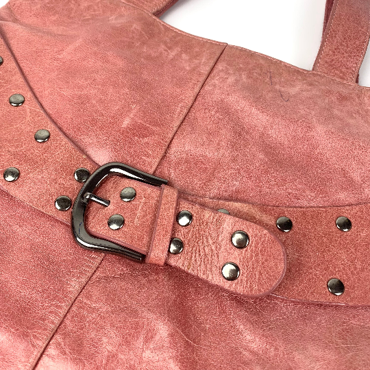 Front studded belt on leather handbag