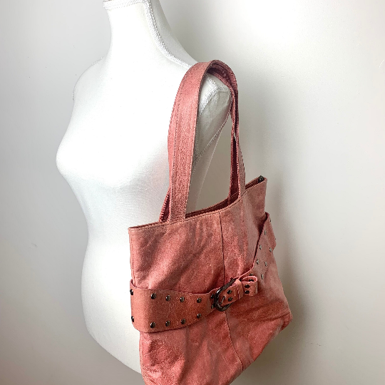 Vintage pink leather bag on mannequin shoulder