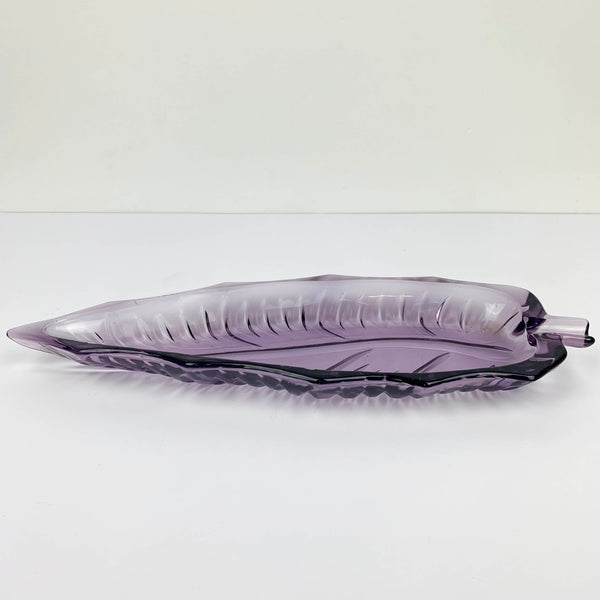 Purple mid century glass leaf shaped dish laying flat for depth