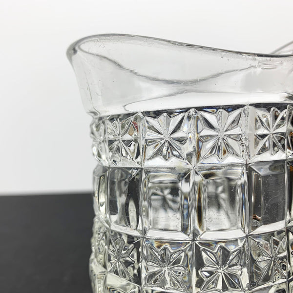 Small diamond cut glass jug spout close up