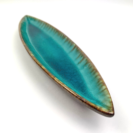 Teal pottery dish with drip glaze