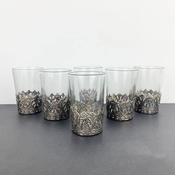 Indian glass tumbler with metal base holders