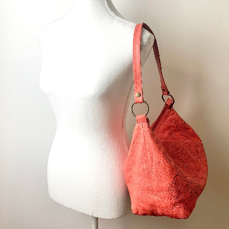 Vintage leather handbag on mannequin shoulder